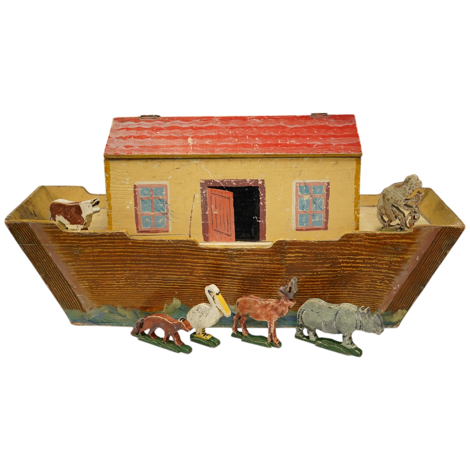 An early 20th century painted pine Noah's Ark and semi-flat animal figures, the hull 68.5cm long. Condition fair, general wear and scuffing to the paintwork.